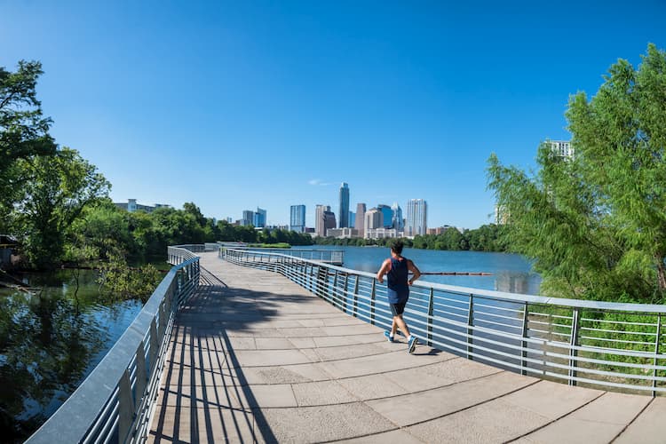 Person running outdoors with Austin skyline in the background