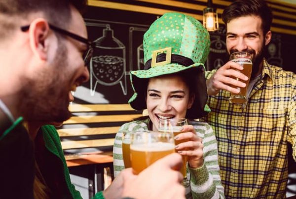 three friends toasting beer at a st patrick's day party