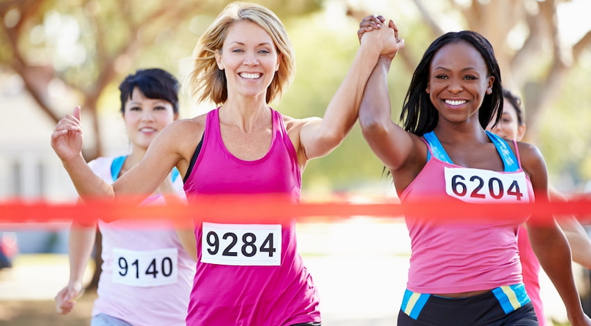 a group of mother cross the finish line at a Houston 5k on Mother's Day