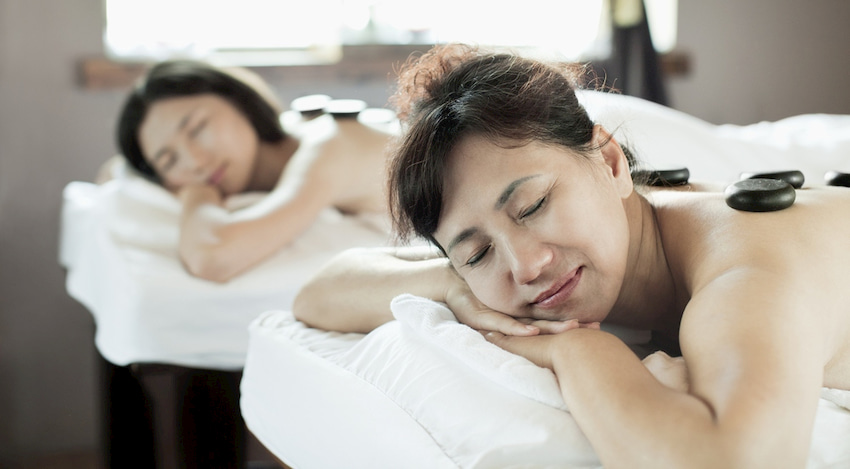 mother and daughter enjoy a relaxing back massage at a spa in Galveston, Texas