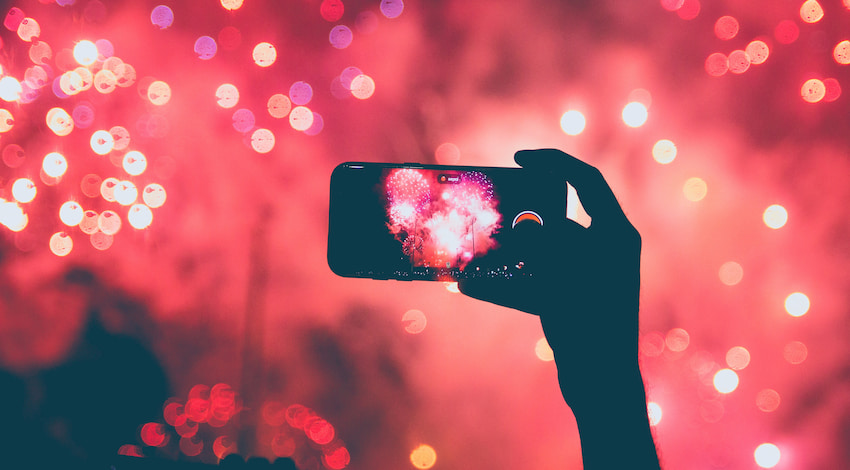 a cell phone takes a photo of a fireworks show in Austin, Texas