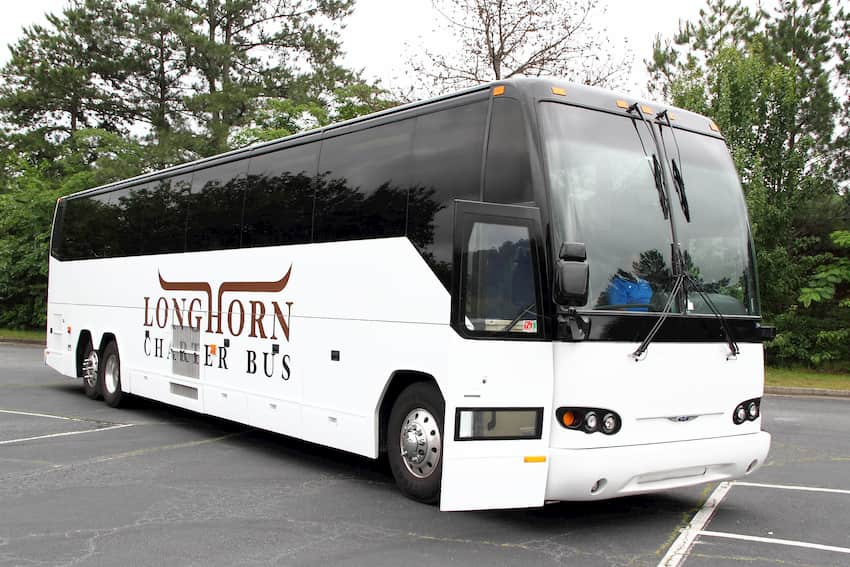 a charter bus from Longhorn waits in a parking lot