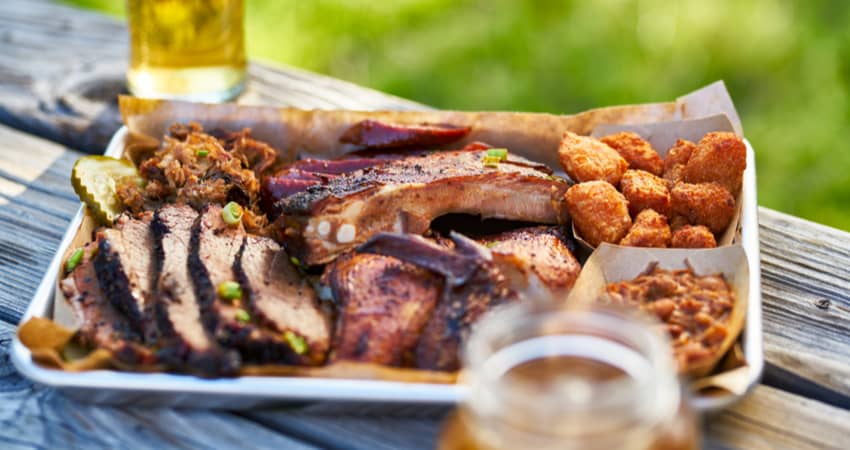 a plate filled with ribs and texas bbq