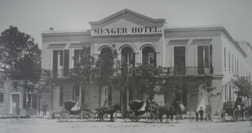 Black and grey historic photo of of the Menger Hotel from 1865. 