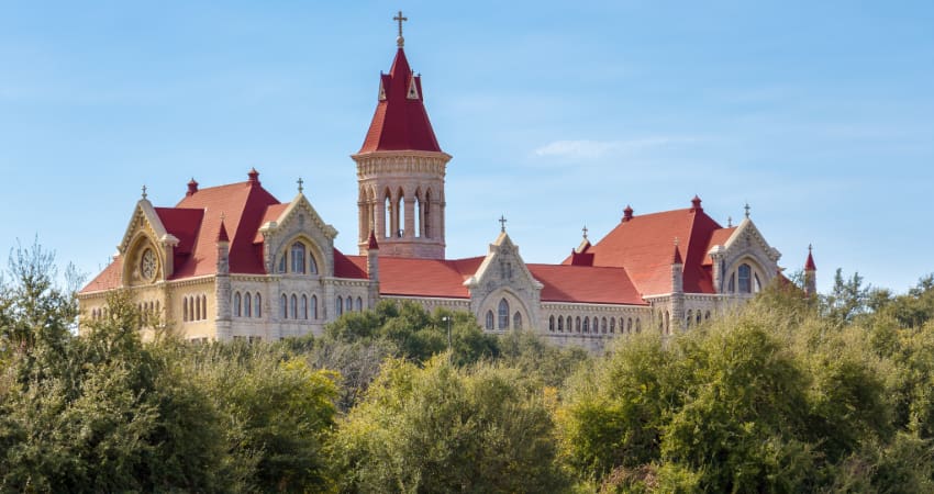 The main building of the Saint Edward's University campus above the treetops