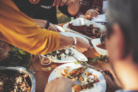 someone sets a plate of food onto a table