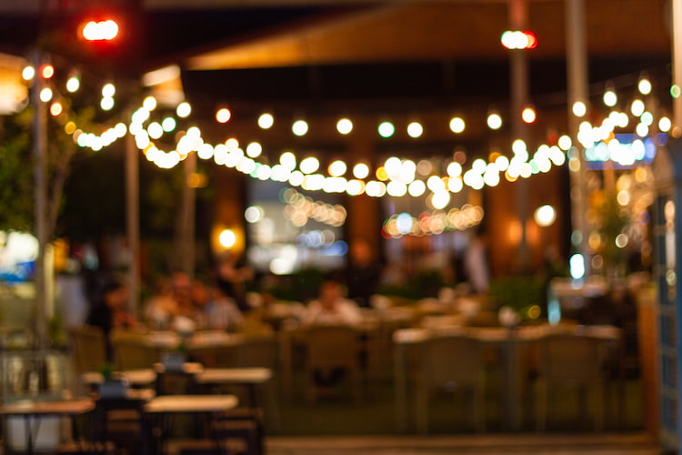 a blurry view of a patio with string lights