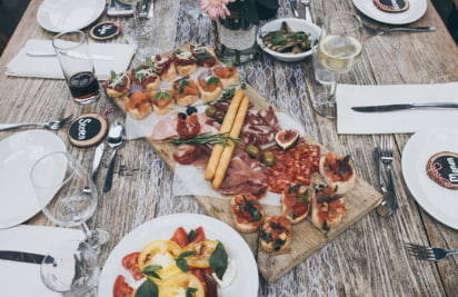 a large dining table filled with plates of food