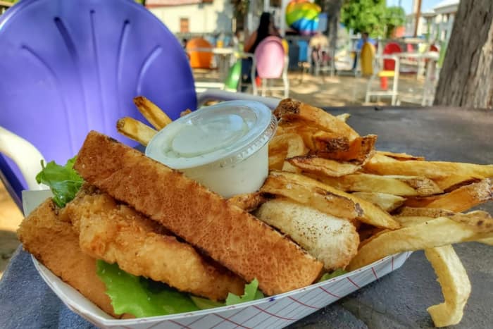 texas toast and french fries in a basket on an outdoor table