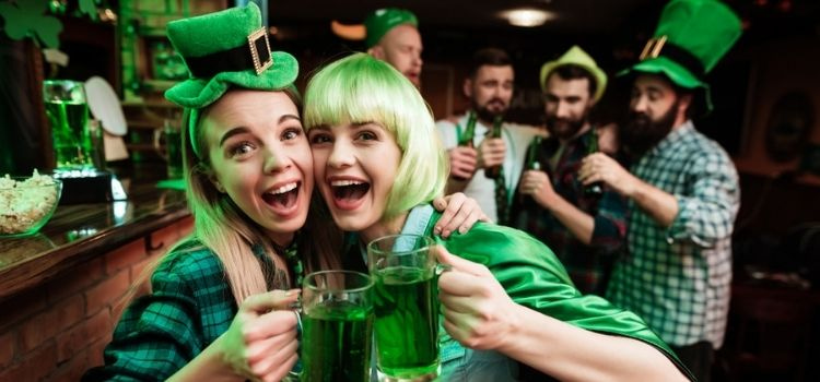 Two girls in a bar celebrate St. Patrick's Day