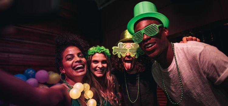 Group of friends enjoying at party in the bar and celebrating St. Patrick's Day