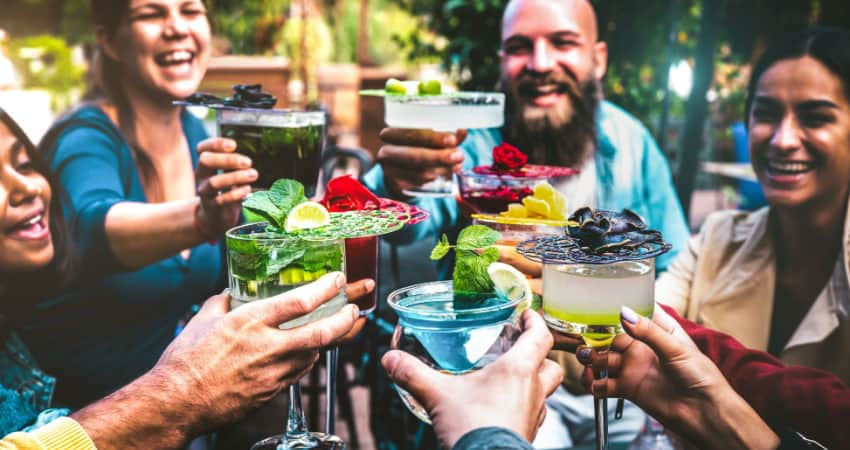 a group of friends toasting margaritas