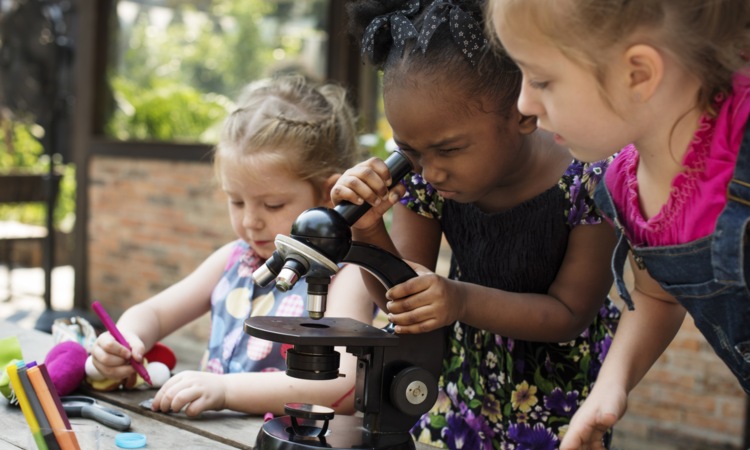 Kids using a microscope