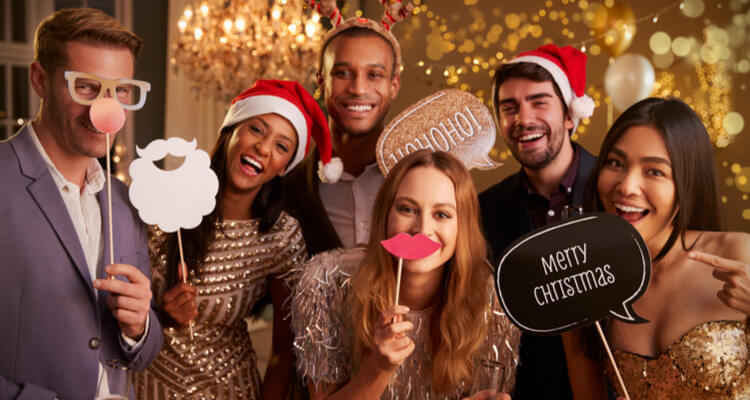 A group of people holding up festival signs at a Christmas party.