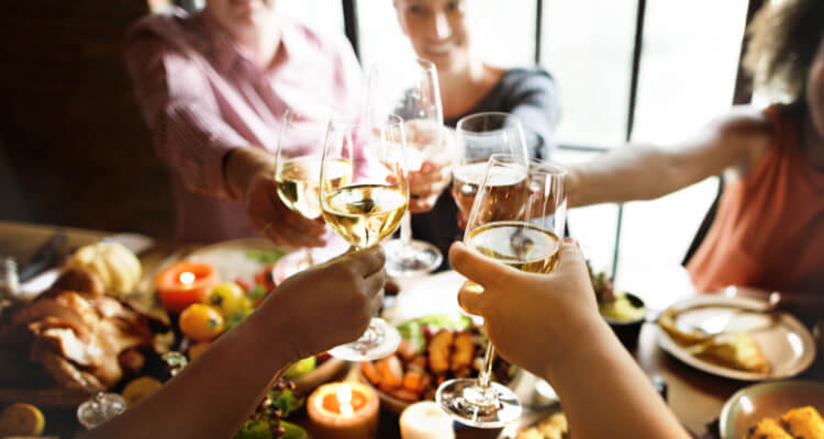 A group of people toasting at Thanksgiving.