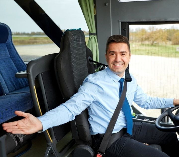 Charter bus driver welcoming passengers